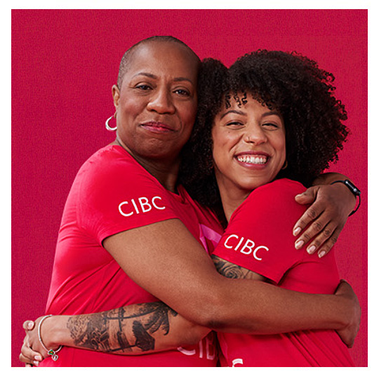 2 woman hugging wearing cibc shirts